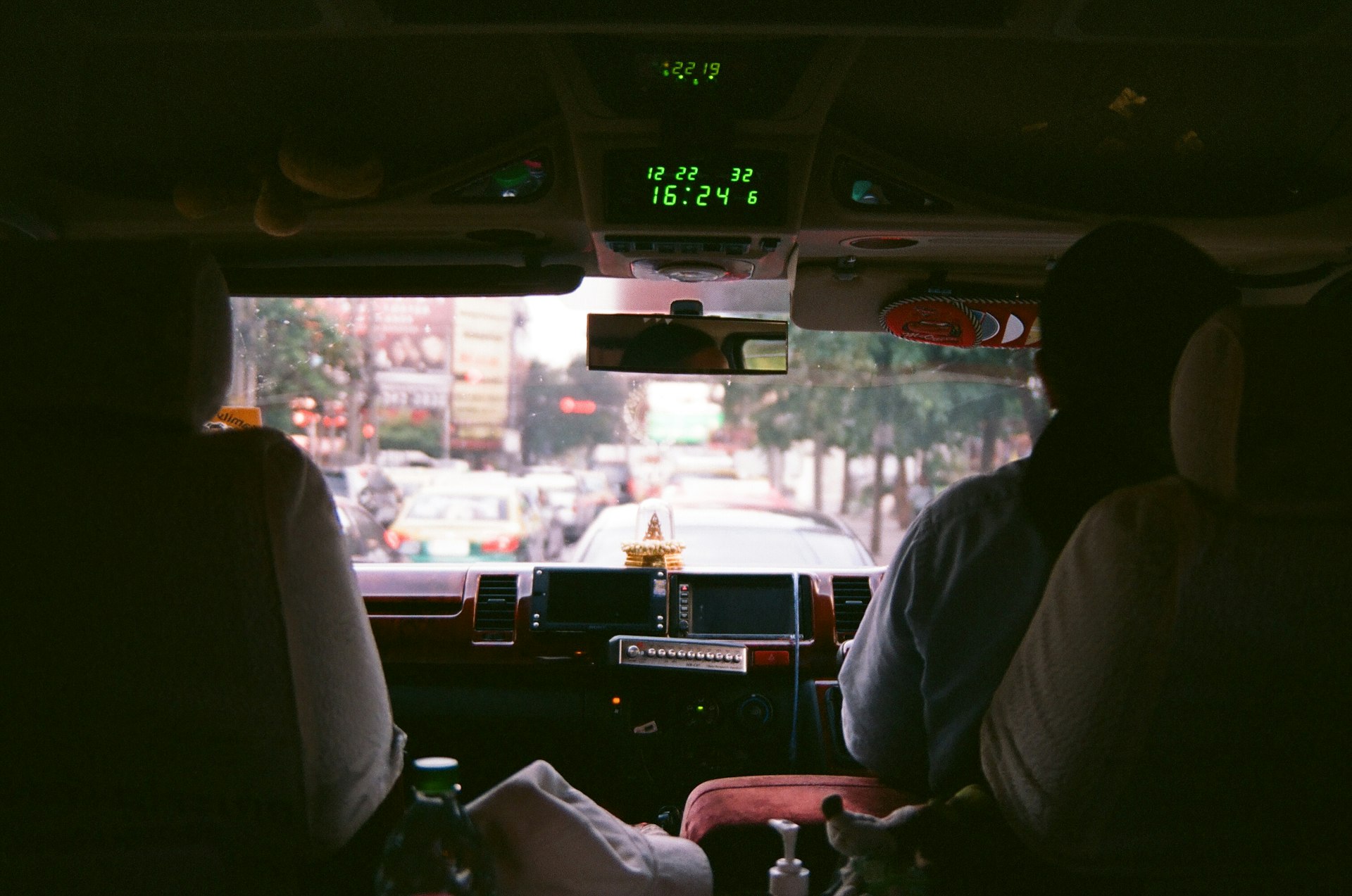 man in white dress shirt driving car during daytime